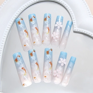Blue gradient koi press-on nails with 3D pink flowers and crystals on heart mirror