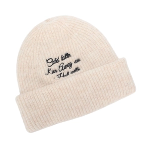 Detailed view of the wide ribbed cuff and black letter embroidery on the knitted beanie