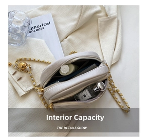 Detailed interior of a beige quilted leather chain bag showing makeup storage capacity