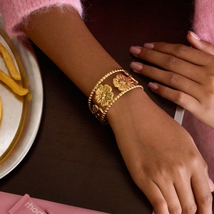 Elegant 18K gold-plated stainless steel open bangle with hollow flower patterns for women