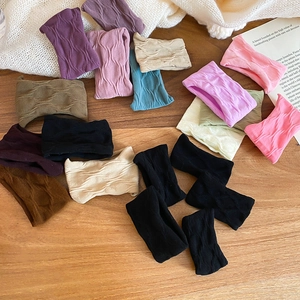 Detailed view of colorful ribbed knit elastic hair ties in assorted pastel and neutral tones