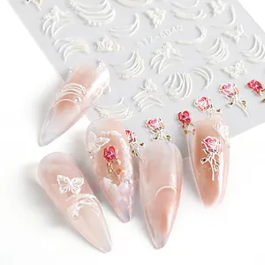 Macro detail of 5D embossed nail art stickers with white butterflies and red roses