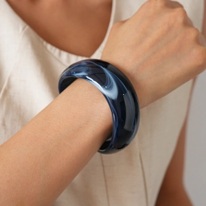Detailed close-up of dark blue marble resin bangle showing smooth polished surface