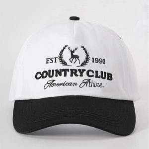 Detail of embroidered EST 1991 deer logo on a black and white baseball cap