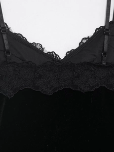 Detailansicht eines schwarzen Samt-Tops mit Spitze am Ausschnitt und feinen Trägern