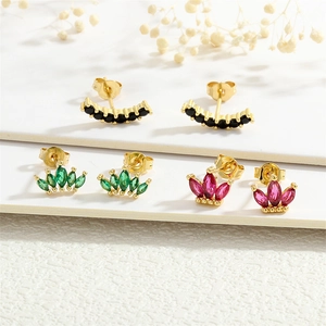 Macro shot of 18K gold plated stud earrings with emerald green and pink zircon stones