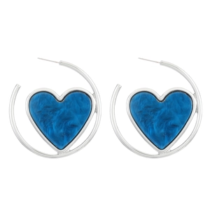 Detail of silver heart hoop earrings with blue marble texture on white background