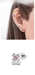 Macro detail of cross stud earrings with pink zircon and screw back closure