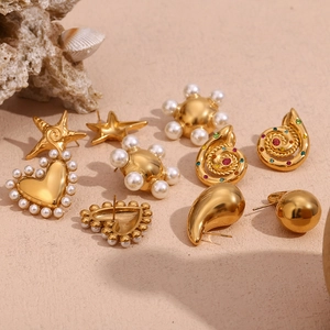 Detailed macro view of 18K gold plated earrings with pearls and colorful zircon stones