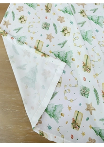 Close-up of waterproof Christmas tablecloth with festive trees and neat hemline details