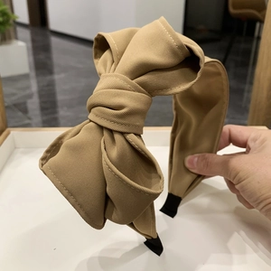 Elegant khaki fabric headband with a large layered bow, stylish vintage hair accessory