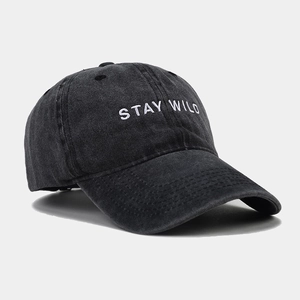 Detailed close-up of STAY WILD embroidery on vintage washed cotton baseball cap