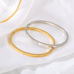 Gold and silver stainless steel hinged bangles with mesh texture and star accents