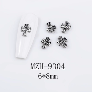 Detail showing 6x8mm vintage silver metal cross nail art charms with 3D embossed texture