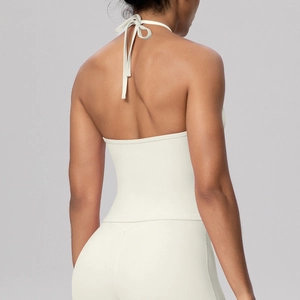 Close-up of white halter yoga top showing elegant back lace-up strings and premium fabric