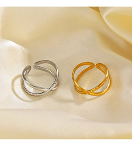 Detail of cross line adjustable rings in gold and silver finish on silk fabric