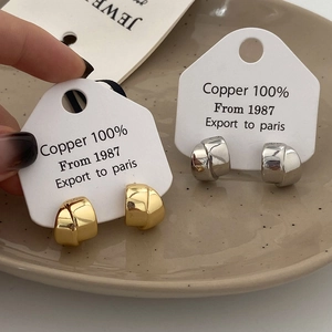 Minimalist twisted knot metal earrings in polished gold and silver finishes