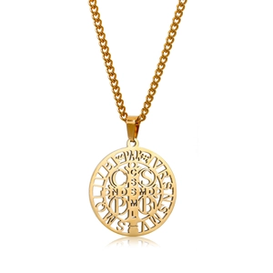 Detailed close-up of golden Saint Benedict medal with cutout cross and Cuban link chain