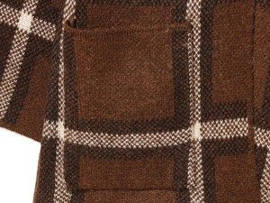 Close-up of brown and beige plaid knit fabric texture and premium pocket stitching