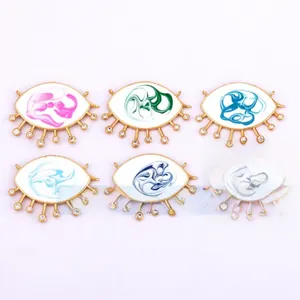 Detail of 6 gold-plated evil eye charms with colorful enamel and sparkling cubic zirconia