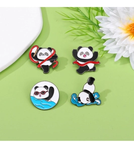 Set of four panda enamel pins playing basketball and soccer on green surface