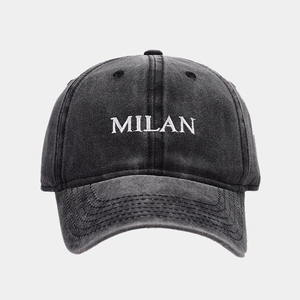 Close-up of white MILAN 3D embroidery on vintage dark grey washed cotton baseball cap