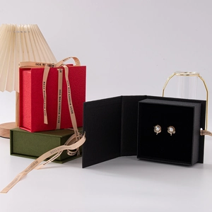 Elegant textured paper jewelry gift boxes in red, green, and black with best wishes ribbons