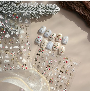 Macro shot of 3D gold embossed Christmas nail stickers with tree and bell designs