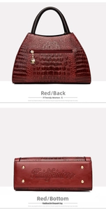 Detail view of red crocodile pattern handbag showing back zipper pocket and metal bottom feet