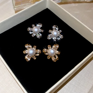Close-up of pearl flower earrings with cubic zirconia in a jewelry box luxury view