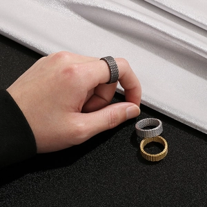 Detailed view of punk style braided rings in black, silver, and gold finish for men