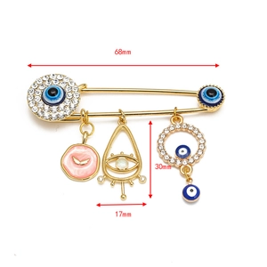 Detailed view of the Evil Eye brooch pins with 68mm dimensions and blue crystal charms