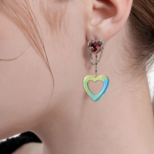 Red heart gemstone earrings with gradient blue-yellow acrylic heart pendant on model