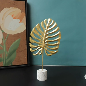 Modern gold monstera leaf ornament on terrazzo base for living room TV cabinet decor