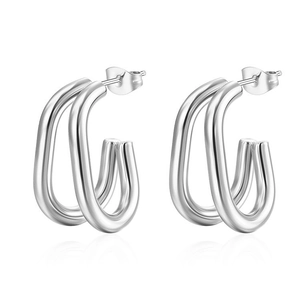 Detail of silver triple-hoop earrings featuring high-polish finish and minimalist design