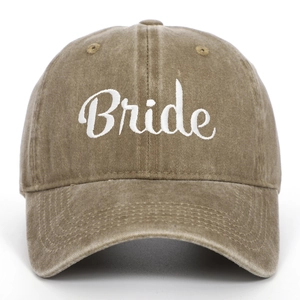 Close-up of white Bride embroidery on vintage washed khaki cotton baseball cap texture