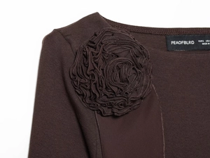 Macro detail of 3D fabric flower on dark brown women T-shirt with brand neck label
