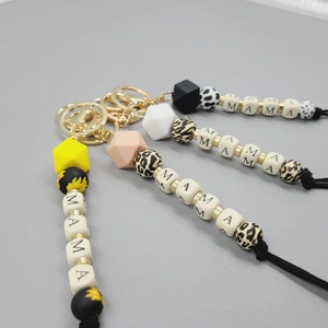 Detail of MAMA letter silicone bead wristlet keychains with floral and animal prints