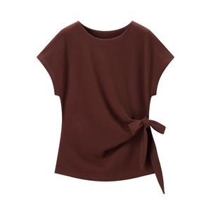 Detail shot of a dark brown top featuring a stylish side tie knot and soft fabric texture
