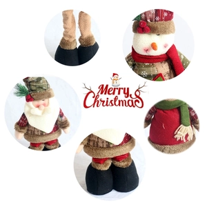 Detailed view of Christmas dolls featuring plush textures, knitted scarves and plaid fabric