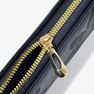 Black embossed leather wallet with a textured surface and gold-tone metal zipper detail