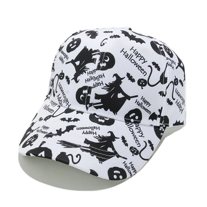 Close-up of Halloween baseball cap with witch, bat and pumpkin patterns on white fabric