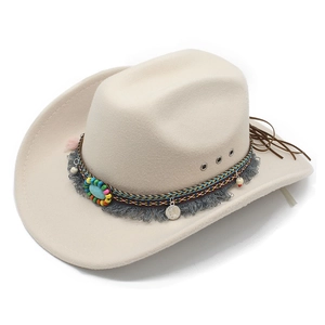 Detail of bohemian cowboy hat with ethnic beads, turquoise, and tassel trim decoration