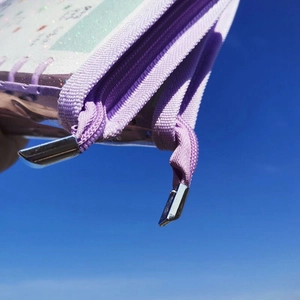 Close-up of purple jewelry organizer binder with durable dual zippers and clear PVC windows
