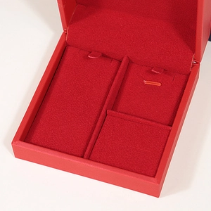 Elegant red brushed leather jewelry box with velvet interior for rings and necklaces