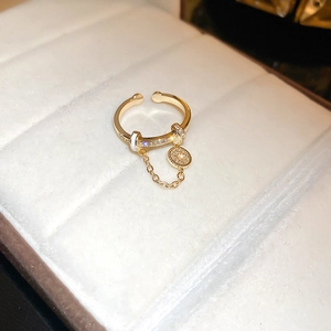 Vintage style gold adjustable ring with a pave crystal charm in a white jewelry box