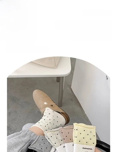 Detail of cotton crew socks set in cream, grey, pink and yellow with black polka dots