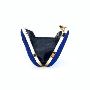 Detail view of navy blue glitter clutch bag with golden metal frame and black lining