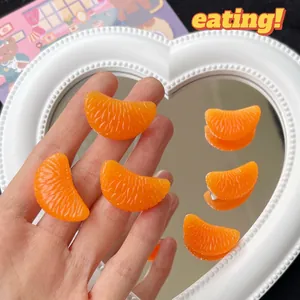 Realistic orange segment hair clip made of resin with shiny pulp texture and metal clip