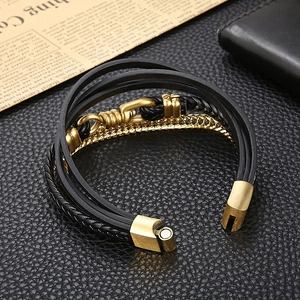 Detail of men's multi-layer black leather bracelet with a gold stainless magnetic clasp